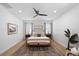 Bright main bedroom features a statement ceiling fan, neutral decor, and lots of natural light from multiple windows at 288 Villa Corte Dr, Lutz, FL 33549