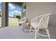 Cozy patio area with comfortable white chairs and a small table, perfect for relaxing outdoors at 288 Villa Corte Dr, Lutz, FL 33549