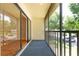 View of the screened-in balcony overlooking the landscaped grounds at 3114 Lake Pine Way # H2, Tarpon Springs, FL 34688