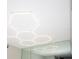 Bathroom illuminated by unique hexagon ceiling lights reflected in a large mirror at 3114 Lake Pine Way # H2, Tarpon Springs, FL 34688