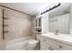 Bathroom featuring tiled shower, vanity, sink, mirror, and cabinet for storage at 3114 Lake Pine Way # H2, Tarpon Springs, FL 34688