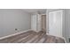 Bedroom features neutral walls, wood-look flooring, and closets with louvered doors at 3114 Lake Pine Way # H2, Tarpon Springs, FL 34688