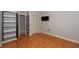 Bedroom featuring wood floors, an open closet, and a mounted TV at 3114 Lake Pine Way # H2, Tarpon Springs, FL 34688