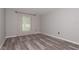 This bedroom has a large window offering natural light and stylish floors at 3114 Lake Pine Way # H2, Tarpon Springs, FL 34688