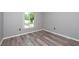 Well-lit bedroom with updated flooring and a large window overlooking the yard at 3114 Lake Pine Way # H2, Tarpon Springs, FL 34688