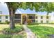 Inviting two-story condo building with lush landscaping, walkway, and screened-in lanais at 3114 Lake Pine Way # H2, Tarpon Springs, FL 34688