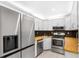 Modern kitchen featuring stainless steel appliances and butcher block countertops at 3114 Lake Pine Way # H2, Tarpon Springs, FL 34688