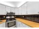 Well-equipped kitchen with stainless steel appliances and ample cabinet space at 3114 Lake Pine Way # H2, Tarpon Springs, FL 34688