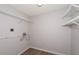 Clean laundry room featuring white wire shelving and light wood-look flooring at 3114 Lake Pine Way # H2, Tarpon Springs, FL 34688