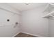 Empty laundry room with white wire shelving and wood-look flooring at 3114 Lake Pine Way # H2, Tarpon Springs, FL 34688