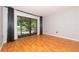 Spacious living room features a sliding glass doors to balcony and laminate wood flooring at 3114 Lake Pine Way # H2, Tarpon Springs, FL 34688