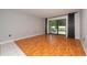 Living room featuring laminate wood flooring and access to the balcony through sliding glass doors at 3114 Lake Pine Way # H2, Tarpon Springs, FL 34688