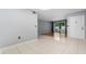Neutral interior with tile flooring and sliding door to the screened porch at 3114 Lake Pine Way # H2, Tarpon Springs, FL 34688