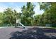 Community playground equipped with slide, seesaw, and spring rider at 3114 Lake Pine Way # H2, Tarpon Springs, FL 34688