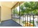 Screened porch with view of parking and mature landscaping at 3114 Lake Pine Way # H2, Tarpon Springs, FL 34688