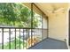 Screened porch with ceiling fan and view of trees and landscaping at 3114 Lake Pine Way # H2, Tarpon Springs, FL 34688