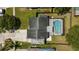 Aerial view of a fenced property featuring a screened-in swimming pool and patio area at 3133 Payne St, New Port Richey, FL 34655