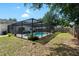 Expansive backyard offers a peaceful retreat with a screened-in pool at 3133 Payne St, New Port Richey, FL 34655
