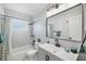 Bright bathroom featuring a tub, modern vanity, black fixtures, and a window for natural light at 3133 Payne St, New Port Richey, FL 34655
