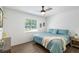 Bright bedroom with wood-look flooring, a modern ceiling fan, and plenty of natural light at 3133 Payne St, New Port Richey, FL 34655