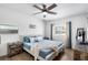 Cozy bedroom with a ceiling fan, light blue bedding, and natural light from two windows at 3133 Payne St, New Port Richey, FL 34655