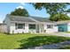 Charming single-story home with a well-maintained lawn, neutral paint, and decorative shutters at 3133 Payne St, New Port Richey, FL 34655
