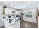 Modern kitchen with white cabinetry, stainless steel appliances, and an island cooktop at 3133 Payne St, New Port Richey, FL 34655