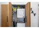 Modern laundry closet with stacked washer and dryer, featuring stylish wooden sliding doors at 3133 Payne St, New Port Richey, FL 34655