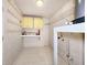 Spacious basement featuring white-painted brick walls, tile floors, and storage shelves at 3304 Alamar St, Lutz, FL 33558
