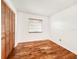 This bedroom features wood-look flooring and a closet with shuttered doors at 3304 Alamar St, Lutz, FL 33558