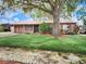 Charming single-story home with a copper roof, beautiful tree, and well-manicured landscaping at 3304 Alamar St, Lutz, FL 33558