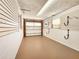 An interior of a garage with slatwall for organizing tools at 3304 Alamar St, Lutz, FL 33558