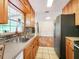 Bright kitchen features stainless appliances, double sinks, light wood cabinetry, and mosaic backsplash at 3304 Alamar St, Lutz, FL 33558