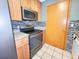Kitchen showcasing stainless steel appliances, wooden cabinetry, and backsplash at 3304 Alamar St, Lutz, FL 33558