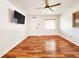 Elegant living room featuring hardwood floors, a ceiling fan, and a window providing natural light at 3304 Alamar St, Lutz, FL 33558