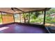 The screened-in patio offers a serene view of the manicured backyard with mature palms at 3304 Alamar St, Lutz, FL 33558