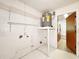 Functional utility room features shelving, water heater, and easy access to the home's interior at 3304 Alamar St, Lutz, FL 33558