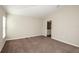 Spacious bedroom featuring neutral walls, soft carpet, and an ensuite bathroom for added convenience at 36958 Sagemoor Dr, Zephyrhills, FL 33541