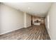 Spacious living room with wood-look floors and views of the modern kitchen at 36958 Sagemoor Dr, Zephyrhills, FL 33541