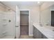 Bright bathroom with double vanity, shower/tub combo, and doorway to carpeted room at 36964 Sagemoor Dr, Zephyrhills, FL 33541