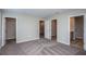 Bedroom with carpeted floors and multiple doors, leading to closets and a bathroom at 36964 Sagemoor Dr, Zephyrhills, FL 33541