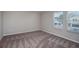 Well-lit bedroom with carpet and bright, natural light from two windows at 36964 Sagemoor Dr, Zephyrhills, FL 33541