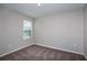 Cozy carpeted bedroom with natural light from a window and neutral color palette at 36964 Sagemoor Dr, Zephyrhills, FL 33541