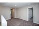 Upstairs hallway with neutral carpet leading to open doorways; bright and airy at 36964 Sagemoor Dr, Zephyrhills, FL 33541