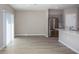 Open floorplan kitchen area with stainless appliances and wood-look floors at 36964 Sagemoor Dr, Zephyrhills, FL 33541