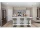 Modern eat-in kitchen featuring stainless appliances, gray cabinets and a center island with seating at 36964 Sagemoor Dr, Zephyrhills, FL 33541