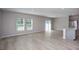 Staged open-concept living and kitchen area with modern furniture and wood-look floors at 36964 Sagemoor Dr, Zephyrhills, FL 33541