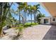 A beautiful backyard with lush landscaping, a waterfront view, and a brick patio at 417 41St Ave, St Pete Beach, FL 33706