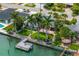 Waterfront home with backyard patio, dock, and manicured landscaping on canal at 417 41St Ave, St Pete Beach, FL 33706