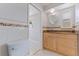 Bright bathroom featuring a toilet and vanity with stylish tile accents at 417 41St Ave, St Pete Beach, FL 33706
